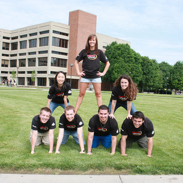 Students on the OTEAM creating a human pyramid with their bodies in the middle of Taylor Hall courtyard in 2010.